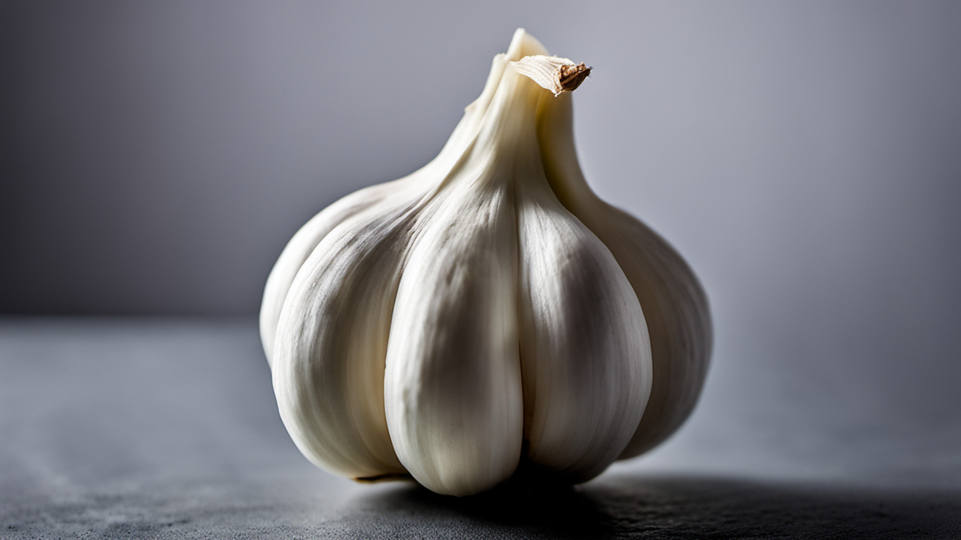 Generated single whole garlic bulb on a gray tabletop